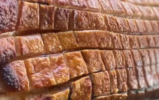 Mouthwatering crackling on Meat joint roasted on spit roast bbq