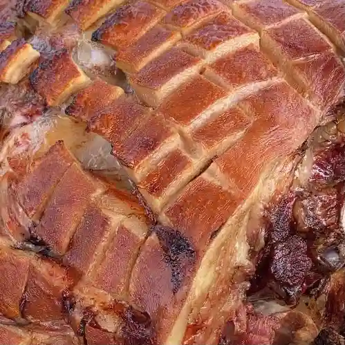 Crackling on hog roast Meat joint roasted on spit roast bbq