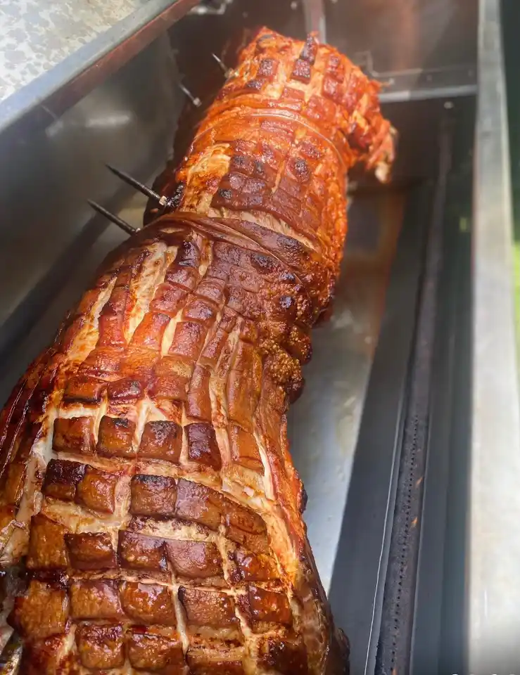 Meat joint roasted on spit roast bbq