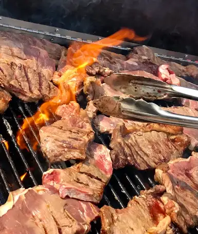meat on bbq grill at catering event