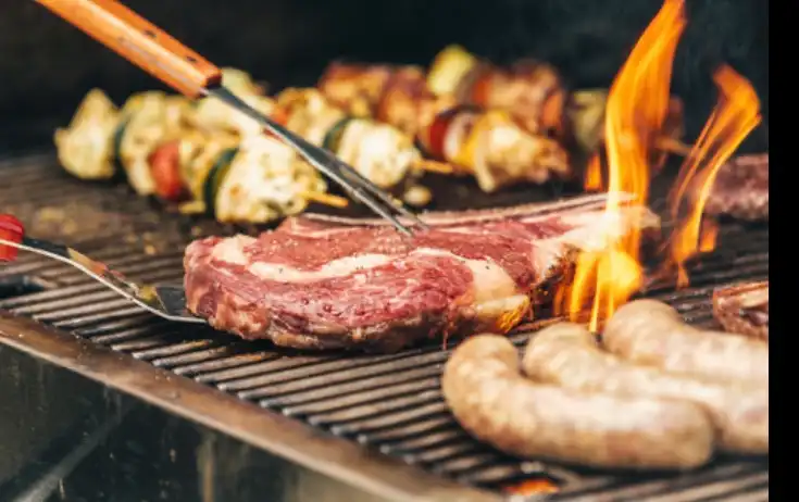 meat on bbq grill at catering event